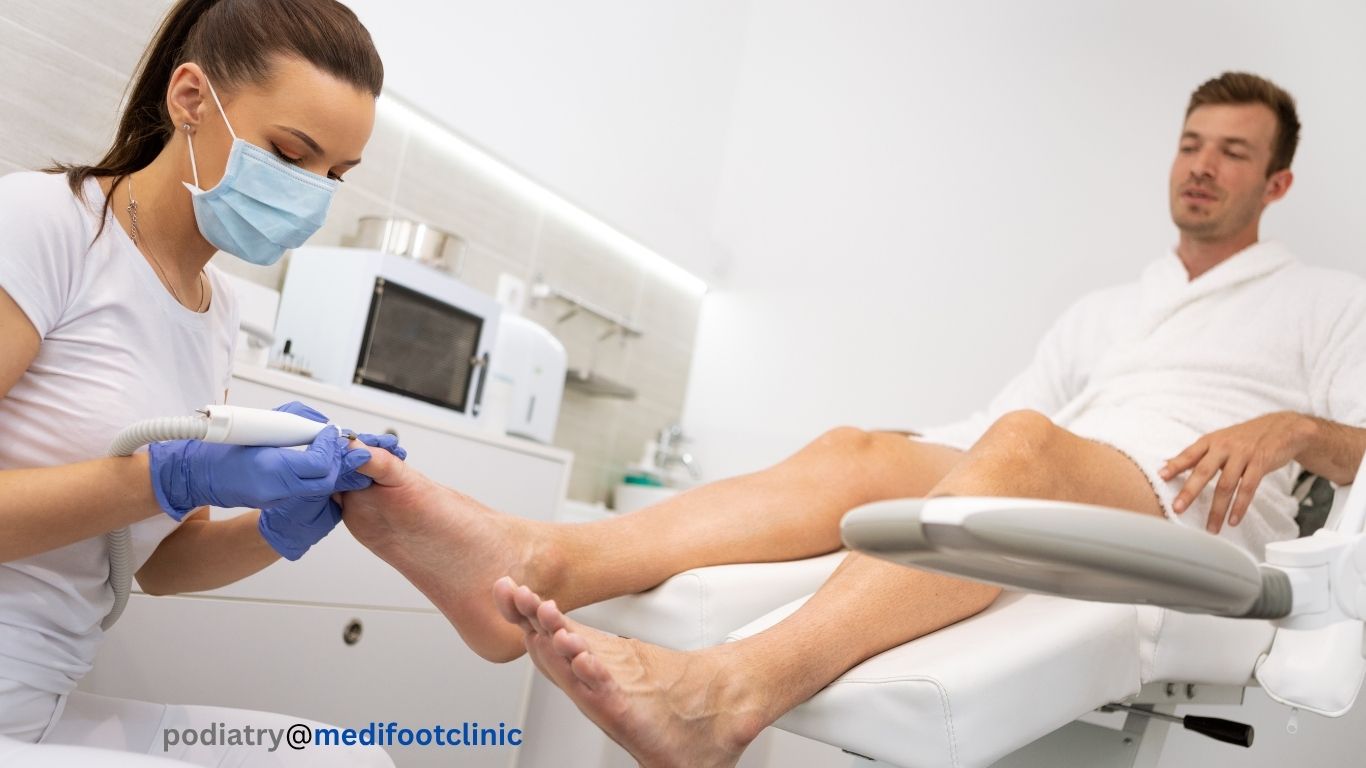 Podiatrist performing nail care treatment on foot