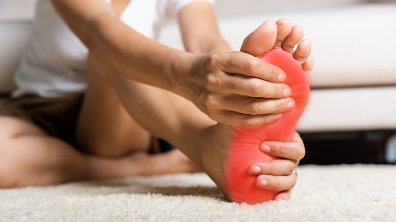 Runner holding heel due to plantar heel pain
